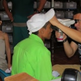 Mission team member performs eye exam at a Honduras clinic
