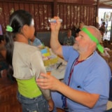 Judah 1 volunteer conducts eye exam at Honduras medical clinic