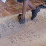 Children use a foot chart to be fitted for shoes in Honduras