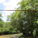 Mission team crosses a narrow footbridge over a river in Honduras