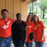 Volunteers meet a resident in Monroe during flood recovery