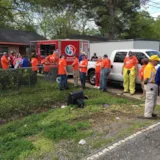 Volunteers coordinate muck-out at a flooded Monroe home