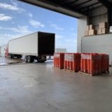 Hurricane Dorian relief buckets are staged by an open trailer