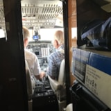 Flight crew at the controls as relief cargo is secured onboard