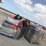 Relief team organizing palletized aid after Hurricane Dorian