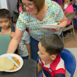 Mission volunteers serve meals to children in Juárez, Mexico