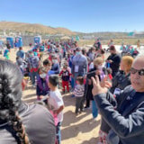 Volunteers guide families lining up for aid in Juárez, Mexico