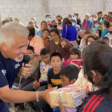 Mission personnel distribute shoes to children in Juárez