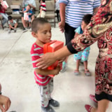 Mission personnel distribute aid to children in Juárez, Mexico