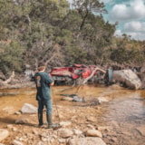 Volunteer surveys flood damage along a Kerrville, Texas creek