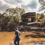 Volunteer surveys flood damage at a riverbank in Kerrville, Texas