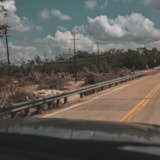 Traffic passes flood debris on a Kerrville, Texas roadway