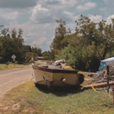 Flood-damaged boat on a Kerrville, TX roadside after flooding