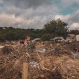 Excavators and crews clear flood debris in Kerrville, Texas