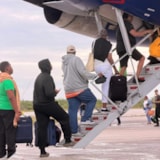 Bahamas evacuees board aircraft after Hurricane Melissa