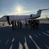 Team gathers beside aircraft for Jamaica after Hurricane Melissa