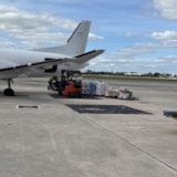 Forklift loads hurricane aid supplies onto aircraft for Jamaica