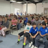 Families gather for an aid presentation in Juárez, Mexico