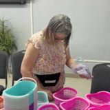 Volunteer sorts aid supplies into baskets in Juárez, Mexico