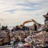 Excavator and volunteers clear rubble after Venezuela quake