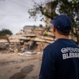 Relief crews and excavator clear rubble after Venezuela quake