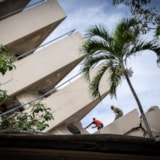 Relief team clears quake debris at a collapsed site in Venezuela