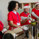 Mission volunteers serve hot meals at a community kitchen