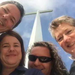 Relief team gathers beneath a cross in Monroe, Louisiana