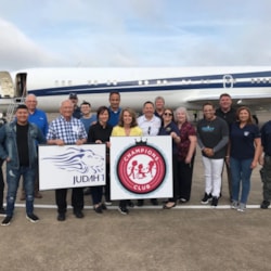 Judah 1 team and partners gather on tarmac for Anchorage center