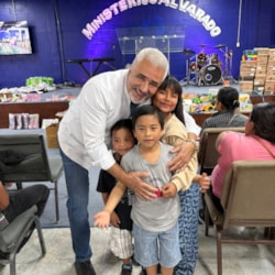 Volunteers greet families during an aid outreach in Juárez