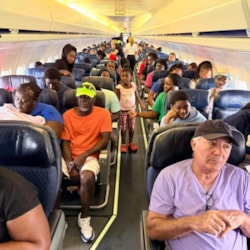 Evacuees on board a flight during Hurricane Melissa, Bahamas