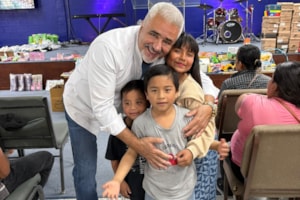 Volunteers greet families during an aid outreach in Juárez