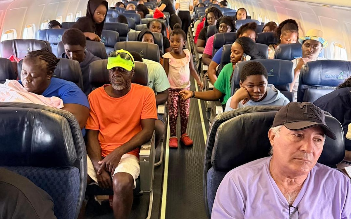 Evacuees on board a flight during Hurricane Melissa, Bahamas