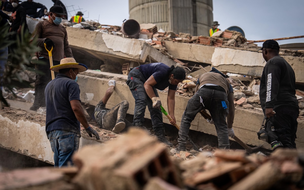 Relief workers dig through collapsed buildings in Venezuela
